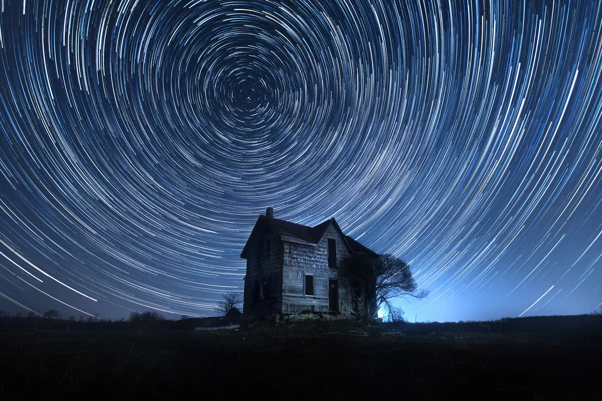 Relic, circular star trails over an abandoned farmhouse in rural Ontario